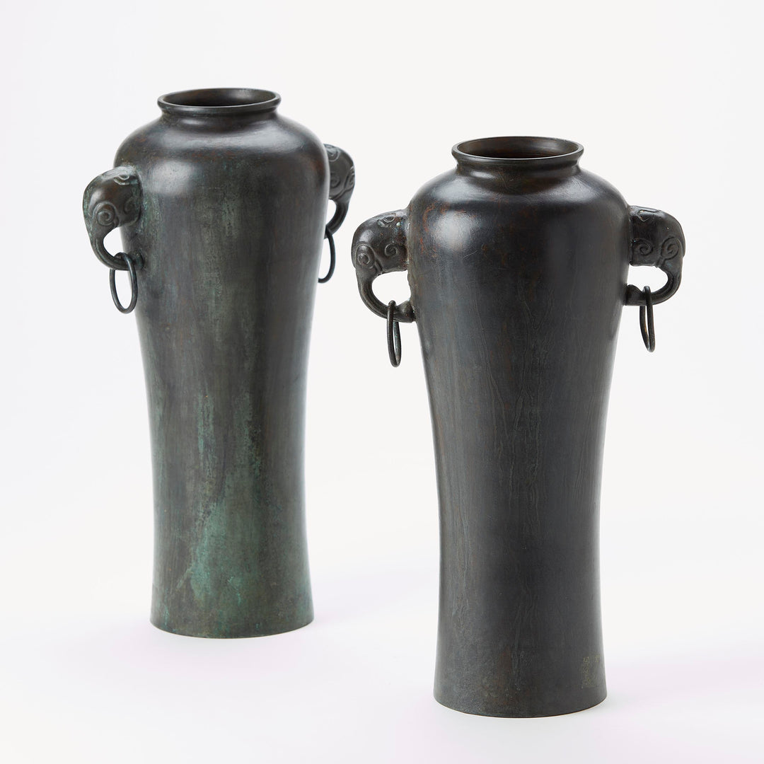 Two bronze vases with animal head handles on a white background