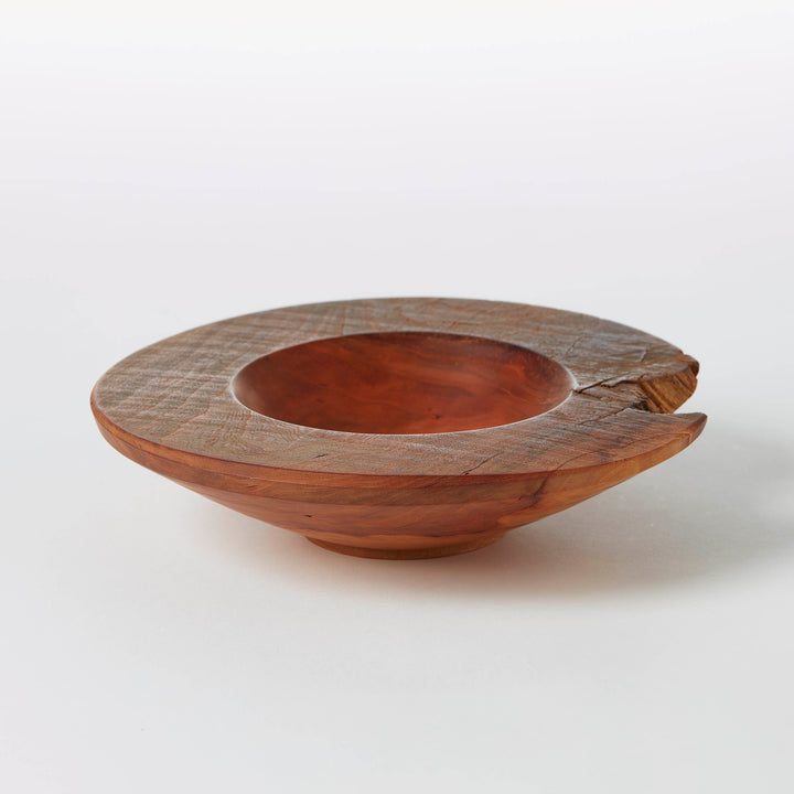 Wooden bowl with a unique design on a white background