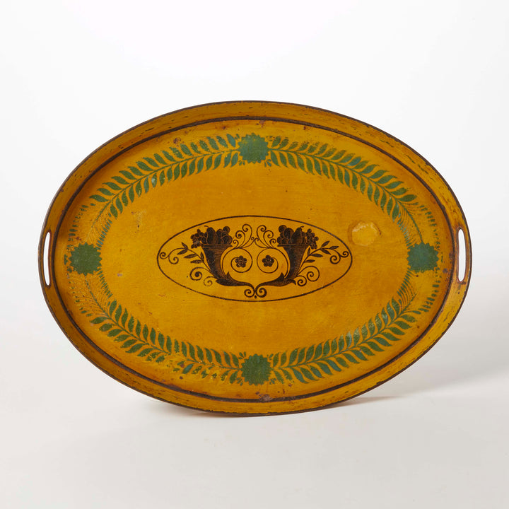 Decorative oval tray with yellow background and green leaf patterns 