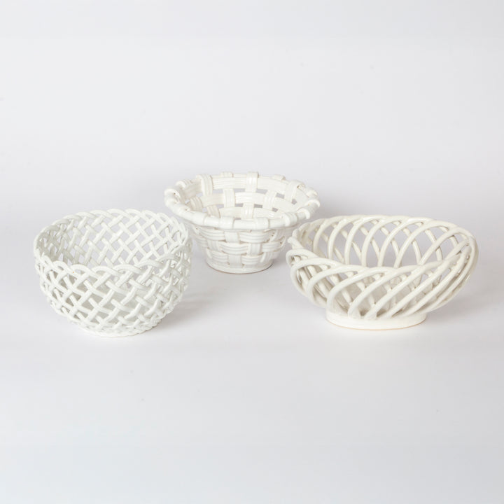 Three small white decorative baskets with woven lattice patterns, arranged on a seamless white background.