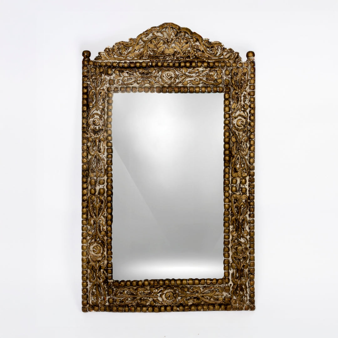 ornate carved wood mirror in the Balinese style