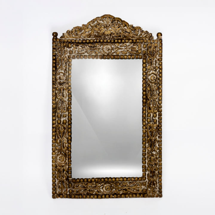 ornate carved wood mirror in the Balinese style