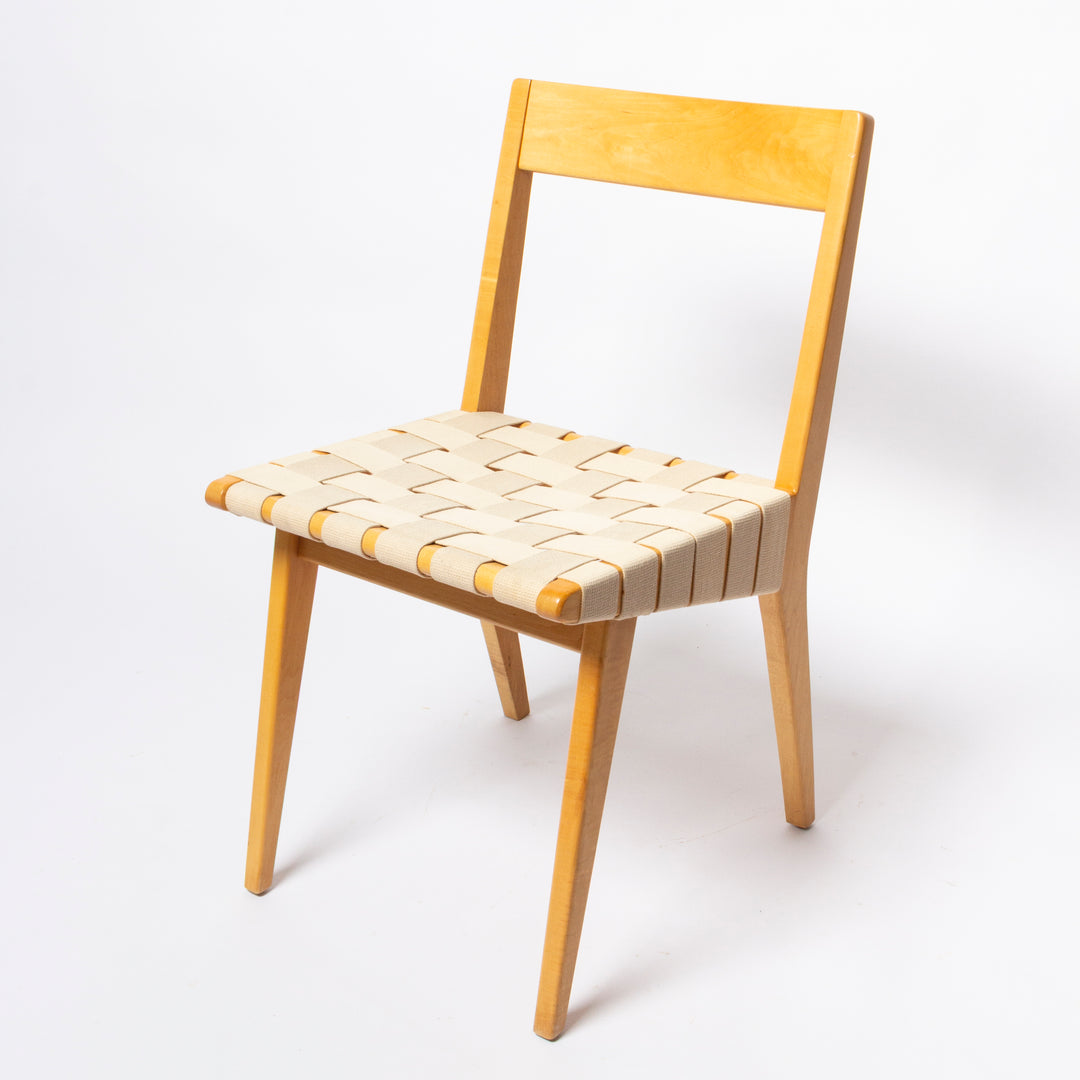 A mid-century modern wooden dining chair with a light natural wood frame and a woven cream leather seat, photographed on a seamless white background.