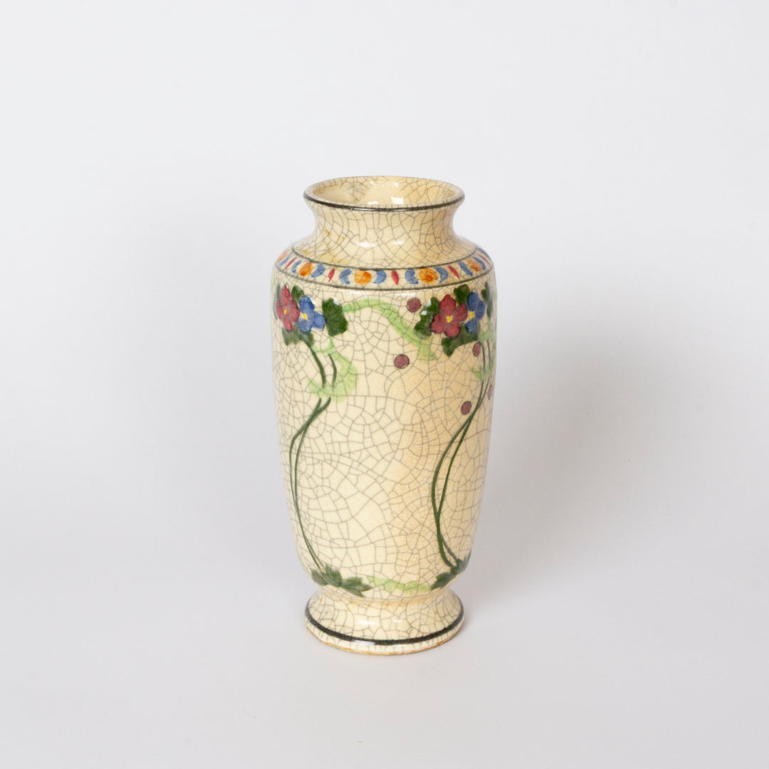 A vintage-style ceramic vase with a cream-colored crackled glaze, decorated with a colorful floral vine pattern and a geometric border at the neck