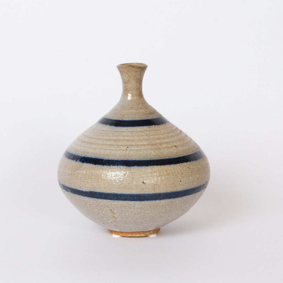 studio pottery vase with blue vertical stripes and narrow neck
