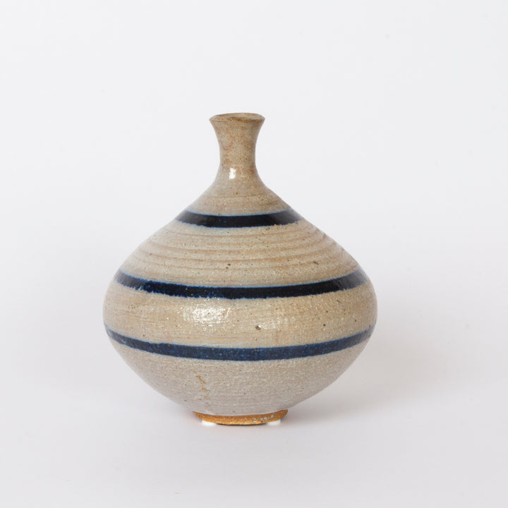 studio pottery vase with blue vertical stripes and narrow neck