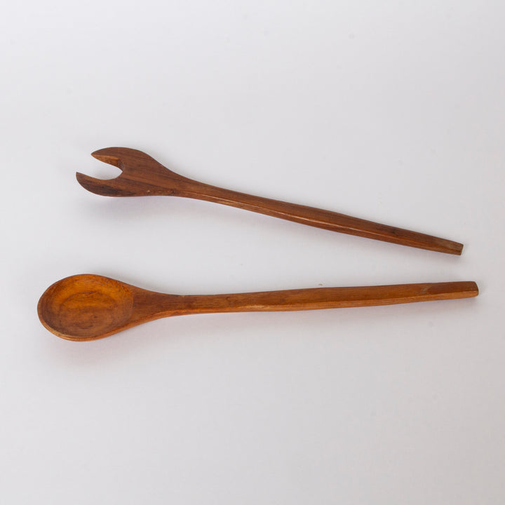 A Danish wooden salad spoon and matching wooden serving fork set, displayed diagonally on a clean white background.