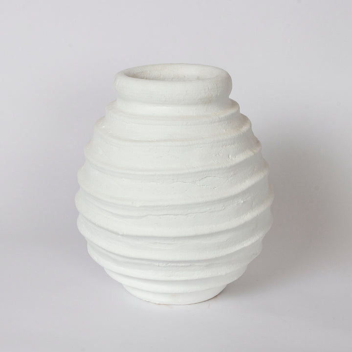 A small white textured ceramic Moroccan vase pot with horizontal ridges