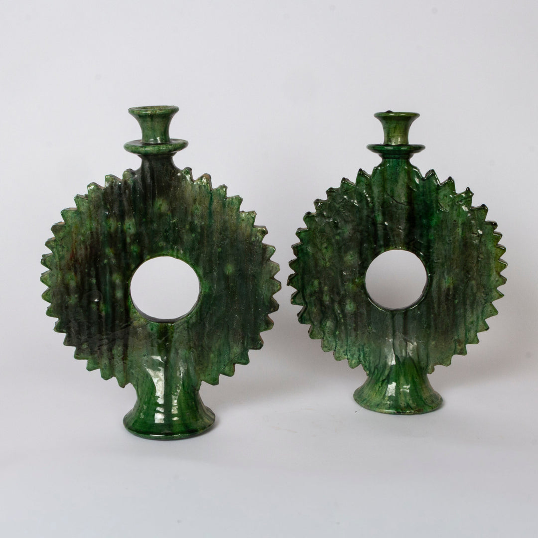 A pair of vintage green ceramic candlesticks shaped l