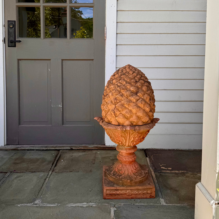Decorative pinecone finial on a pedestal 