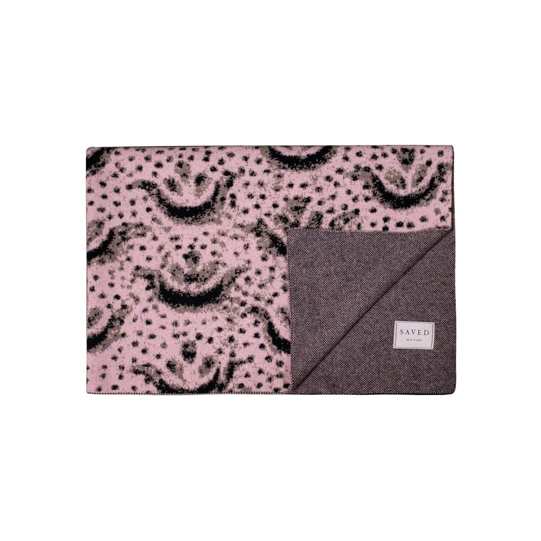 folded cashmere blanket with abstract pink and black design